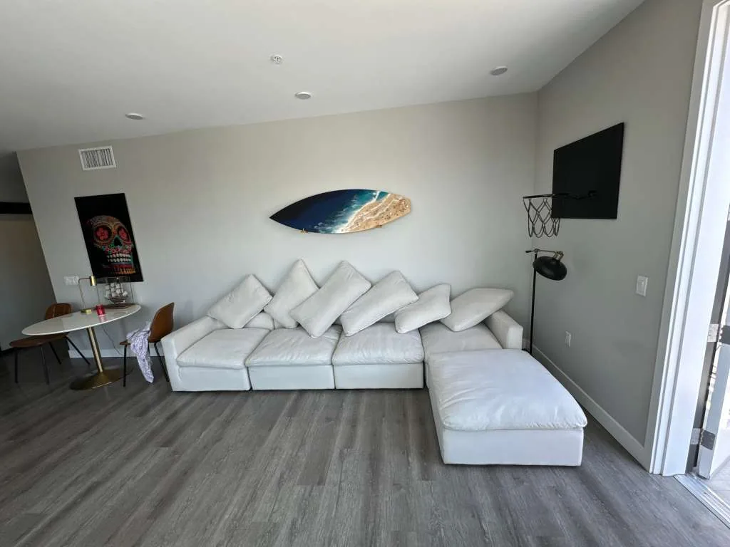 White modular fabric sectional and ottoman cleaned in a living room