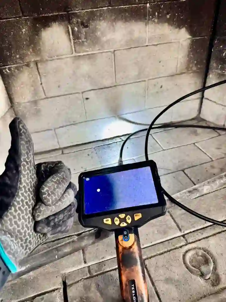 Go4Cleaning technician running a chimney camera inspection inside a firebox
