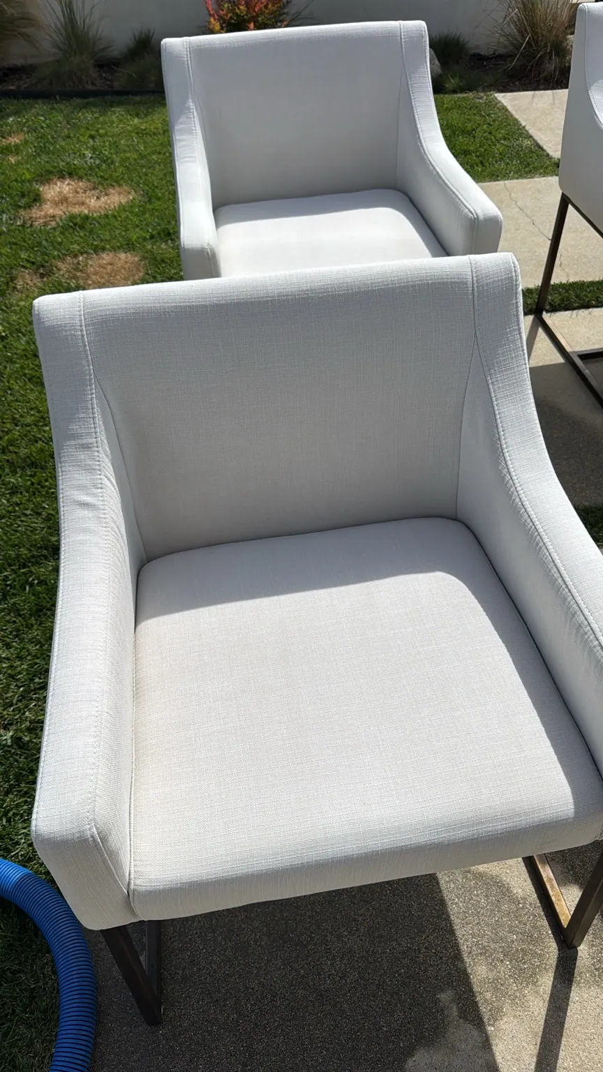 White fabric armchairs cleaned outdoors by Go4Cleaning