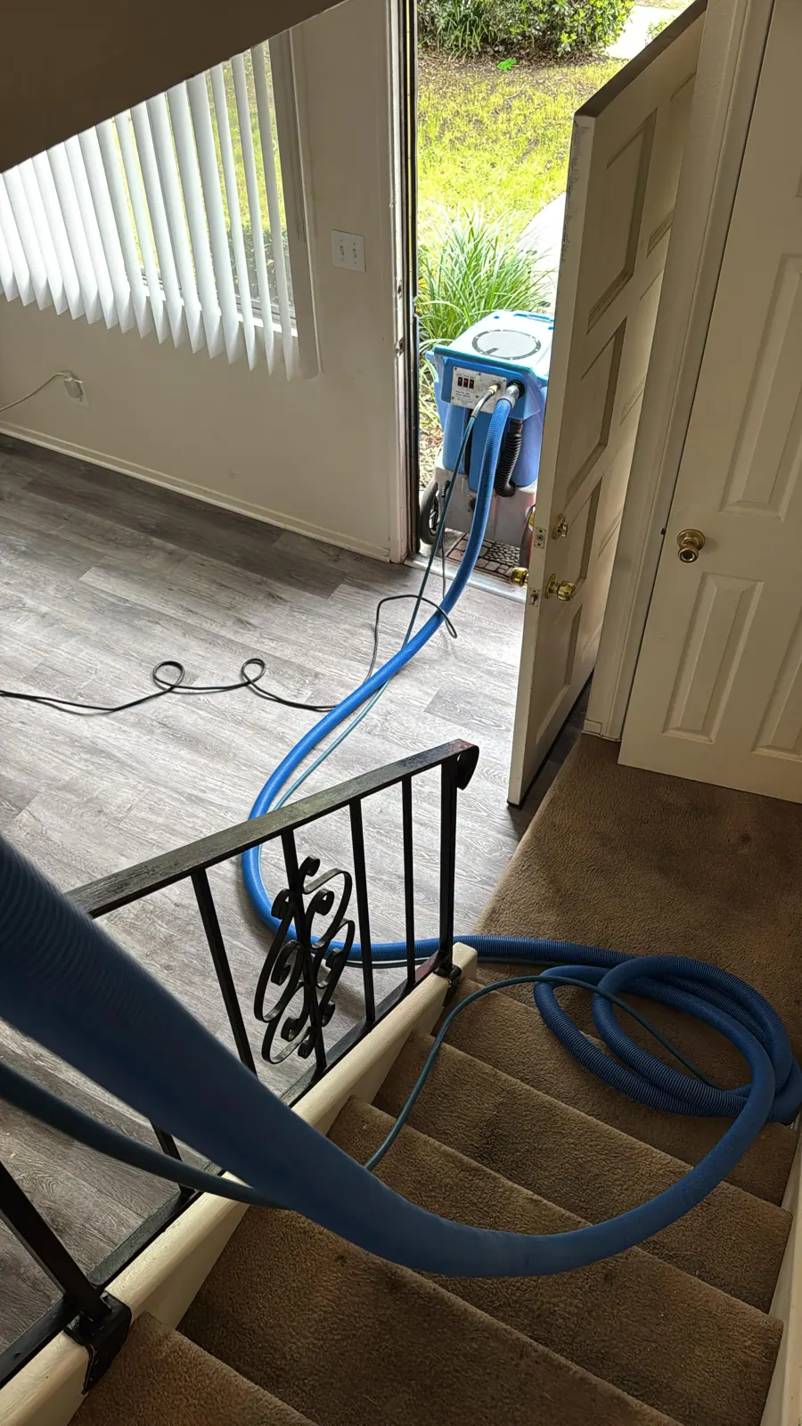 Go4Cleaning extraction hose run through a home entry to the stairs