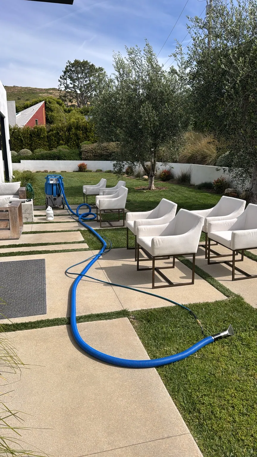 Outdoor patio chairs being cleaned with a Go4Cleaning extraction hose