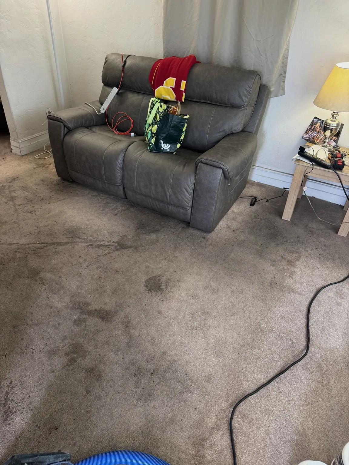 Carpet cleaning in a living room with recliner seating