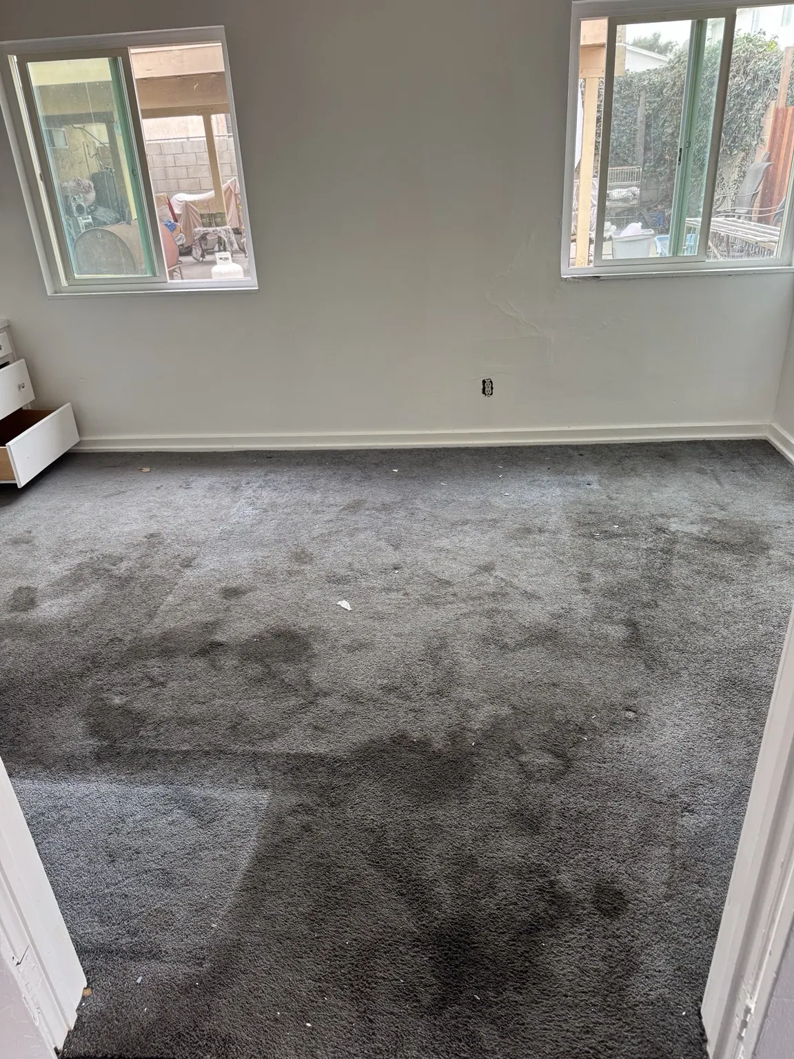 Dark carpet showing heavy soiling before cleaning