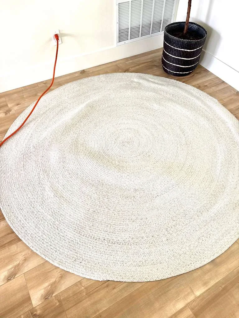 Large round braided natural-fiber rug after cleaning
