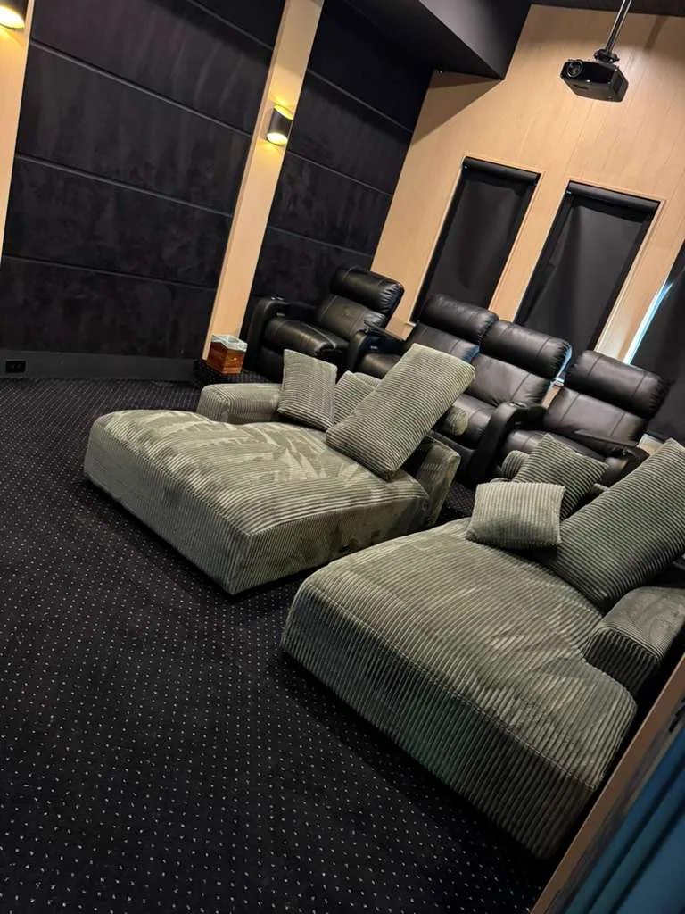 Green corduroy lounge seating cleaned in a home theater room