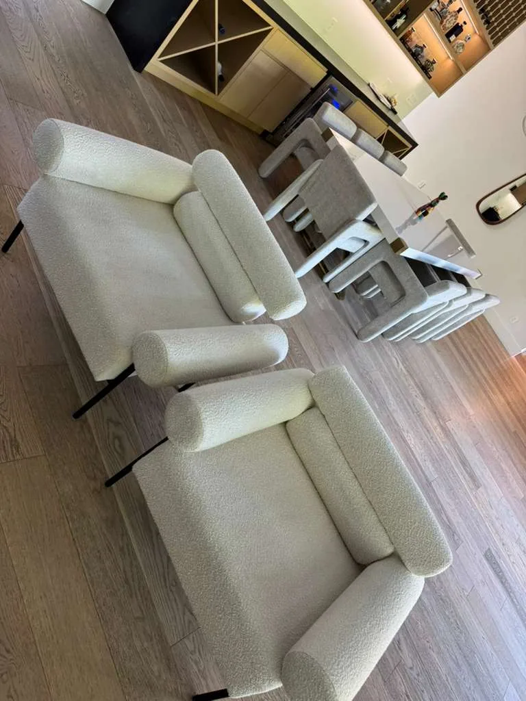 Pair of cream boucle armchairs cleaned in a dining area