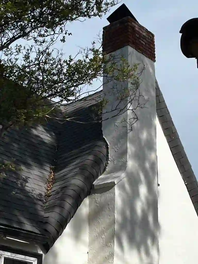 Brick chimney and cap above a shingle roof on a Los Angeles home