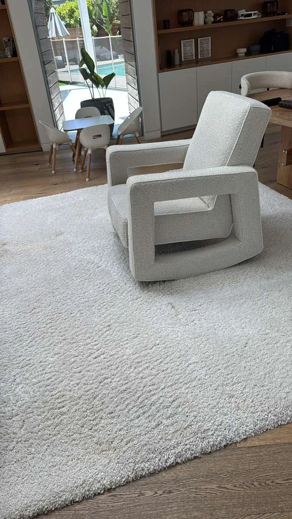 Boucle swivel armchair cleaned beside a shag rug