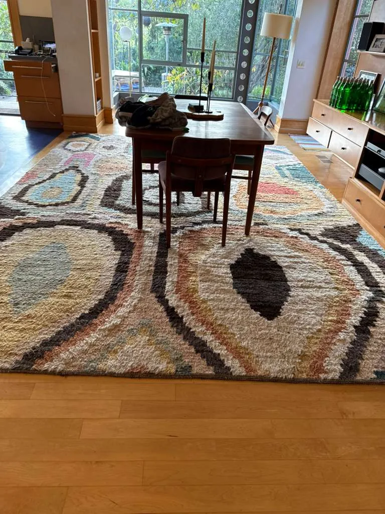 Thick wool shag rug under a dining table after on-site rug cleaning