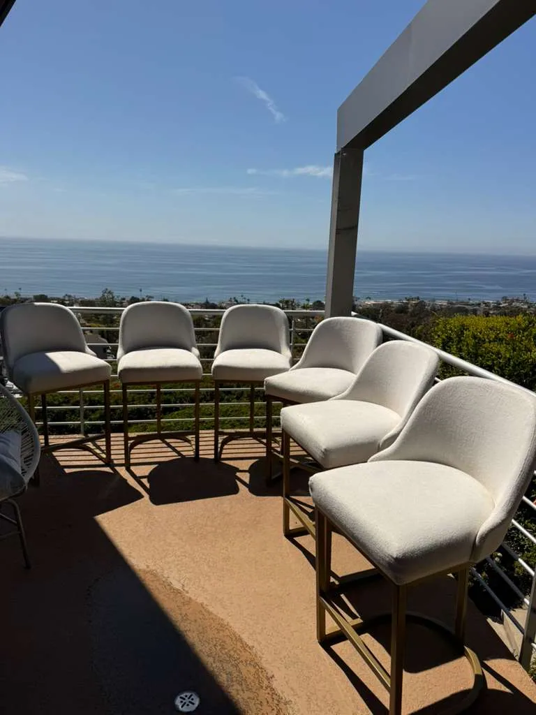 Upholstered bar stools cleaned on an ocean-view terrace