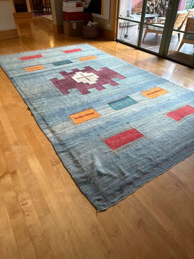 Blue flatweave kilim rug cleaned in place on hardwood flooring