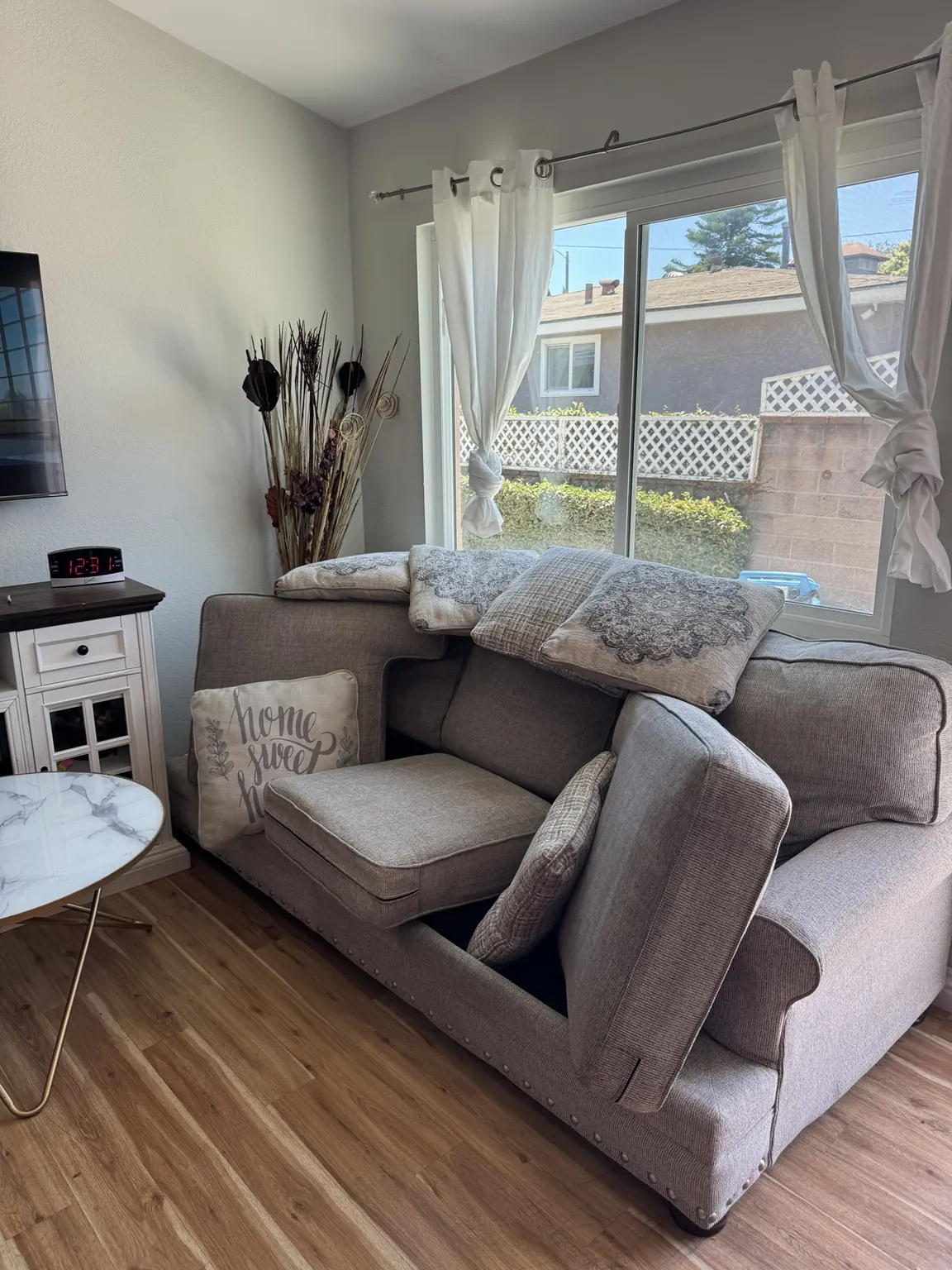 Gray sofa cleaned beside a living room window